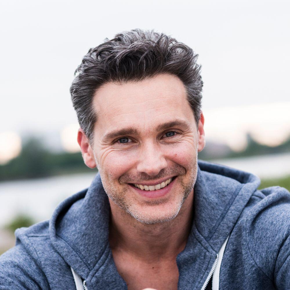 portrait of smiling man at the riverside B6W5EHB 1 2
